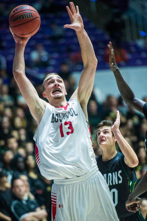 Chris Detrick  |  The Salt Lake Tribune
Bountiful's Jeffrey Pollard (13) shoots past Kearns's Tayler Marteliz (10) during the 4A championship game at the Dee Events Center Saturday February 28, 2015.  Bountiful is winning the game 36-16 at halftime.