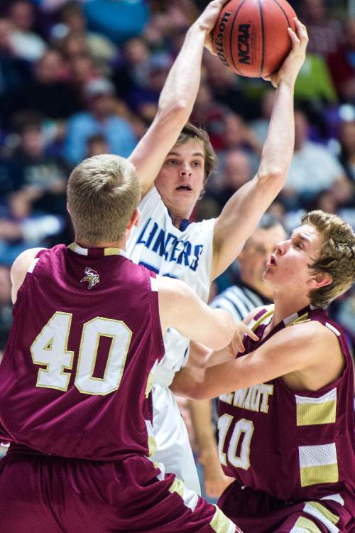 Chris Detrick  |  The Salt Lake Tribune
Layton's Cody Edwards (32) is guarded by Viewmont's Mikele Jenkins (40) and Viewmont's Jacob Walker (10)  during the 5A semifinal game at the Dee Events Center Friday February 27, 2015.  Layton defeated Viewmont 48-41.