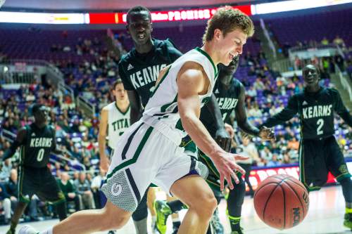 Chris Detrick  |  The Salt Lake Tribune
Olympus's Miles Keller (23) runs around Kearns's Buay Kuajian (11) during the 4A semifinal game at the Dee Events Center Friday February 27, 2015.  Kearns defeated Olympus 63-52