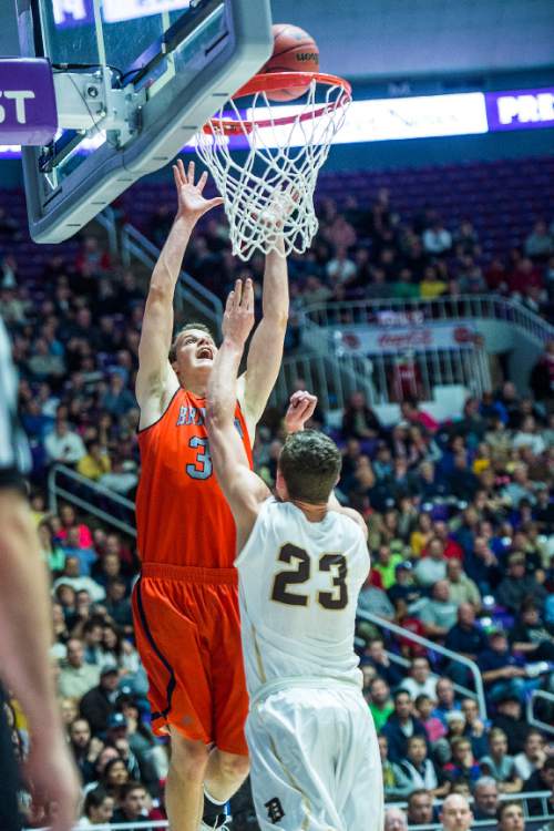 Chris Detrick  |  The Salt Lake Tribune
Brighton's John Gremillion (32) shoots past Davis' Benjamin Rigby (23) during the 5A semifinal game at the Dee Events Center Friday February 27, 2015.  Brighton defeated Davis 64-62.