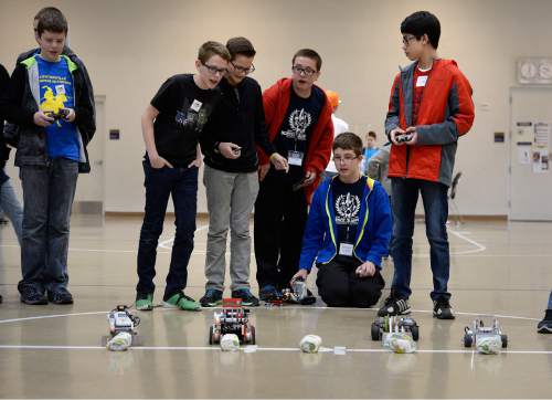 Scott Sommerdorf   |  The Salt Lake Tribune
Alex Stevens, of West High, at right in the red coat, watches as he and others compete in the "Robocross" event where motorized vehicles pushed Subway sandwiches across the floor. Stevens won the event. Westminster College hosted 500 middle and high school students as they competed in the 2015 Northern Regional Science Olympiad, Saturday, February 28, 2015.