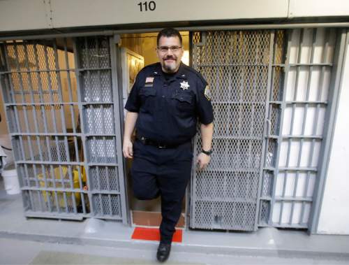 Warden Scott Crowther walks out of a cell in Wasatch A-East block during a media tour Thursday, Feb. 26, 2015, at the Utah State Correctional Facility in Draper, Utah. Gov. Gary Herbert said Thursday that he's opposed to the idea of allowing a state commission to pick a location to build a new prison instead of leaving the decision with the Legislature. (AP Photo/Rick Bowmer, Pool)