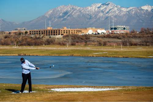 Chris Detrick  |  The Salt Lake Tribune
In mid-fifty degree weather, Ryan Jones, of Farmington, plays golf at Mulligans Golf And Games Wednesday January 7, 2015.