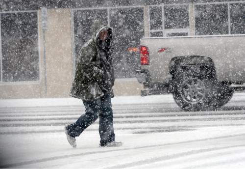 Al Hartmann  |  The Salt Lake Tribune
Bundled up man walks through near white-out conditions as intense snow falling along State Street in Salt Lake City Tuesday morning March 3.