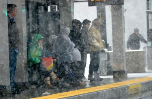 Al Hartmann  |  The Salt Lake Tribune
Bundled up people walk wait at Trax stop during white-out conditions as intense snow falls along Main Street in Salt Lake City Tuesday morning March 3.