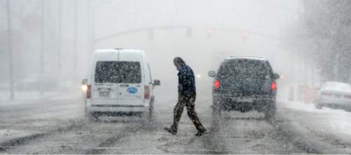 Al Hartmann  |  The Salt Lake Tribune
Bundled up people walk through near white-out conditions as intense snow falls along Main Street in Salt Lake City Tuesday morning March 3.