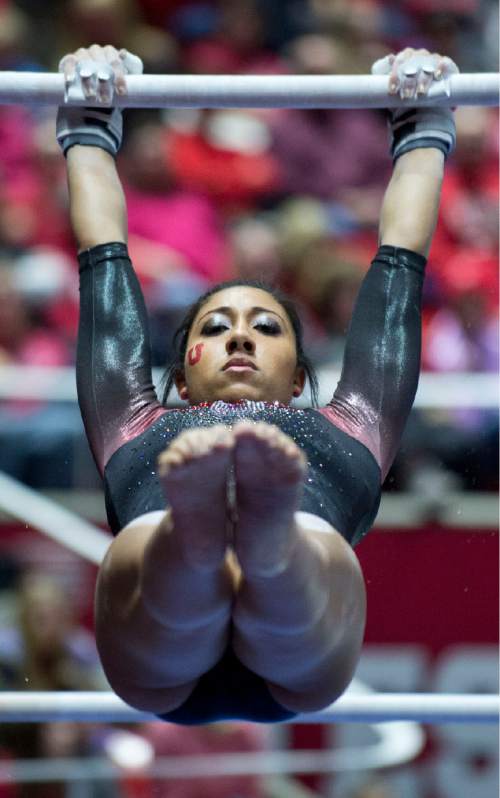 Lennie Mahler  |  The Salt Lake Tribune
Kassandra Lopez performs a 9.875 routine on the bars during a super meet at the Huntsman Center on Friday, Jan. 16, 2015.