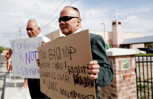 Ashley Detrick  |  The Salt Lake Tribune
Keliti Mahe, right, and Sosaia Haukinima protest outside the Tongan United Methodist Church on Sept. 23, 2012. The two and other church members were upset by the removal of Rev.Filimone Havili Mone as pastor of the West Valley City church.