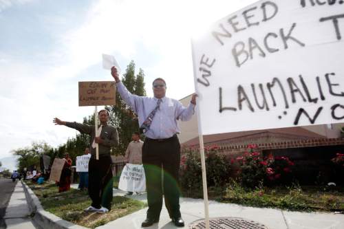 Ashley Detrick  |  The Salt Lake Tribune
Daunibau Lotaki waves to passersby during a protest at the Tongan United Methodist Church on Sunday Sept. 23, 2012.