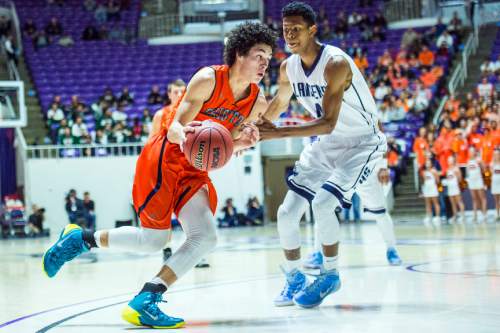 Chris Detrick  |  The Salt Lake Tribune
Brighton's Simione Fehoko (1) runs past Layton's Kedric Kemp (4) during the 5A championship game at the Dee Events Center Saturday February 28, 2015.  Brighton is winning the game 27-20 at halftime.