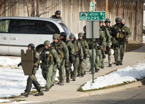 Rick Egan  |  The Salt Lake Tribune
Swat team members get into position on Thursday near 9200 South and Quail Hollow Drive in Sandy. A 37-year-old male was found dead in the home after the 5 hour standoff.