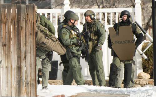 Rick Egan  |  The Salt Lake Tribune

Swat team members get into position, near 9200 South and Quail Hollow Drive in Sandy.  A 37-year-old male was found dead in the home after the 5 hour stand off,  Thursday, March 5, 2015
