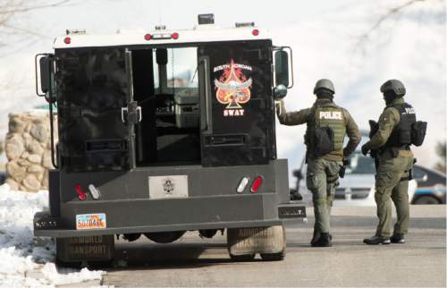 Rick Egan  |  The Salt Lake Tribune

Swat team members, near 9200 South and Quail Hollow Drive in Sandy.  A 37-year-old male was found dead in the home after the 5 hour stand off,  Thursday, March 5, 2015