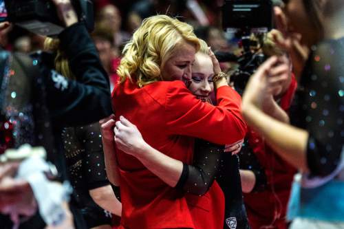 Chris Detrick  |  The Salt Lake Tribune
Utah's Georgia Dabritz gets a hug from coach Megan Marsden after competing on the bars during the gymnastics meet against Michigan at the Jon M. Huntsman Center Friday March 6, 2015. Utah defeated Michigan 198.250 to 197.675. Dabritz scored a perfect 10 on the bars.