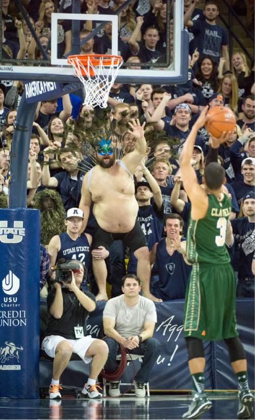 Rick Egan  |  The Salt Lake Tribune

Aggie fan"Wild Bill" Sproat wears peacock feathers, as he tries to distract Colorado State Rams guard Gian Clavell (3), as he returns to the Smith Spectrum for one game only, in basketball action, Utah State vs. Colorado State basketball, in Logan, Saturday, March 7, 2015