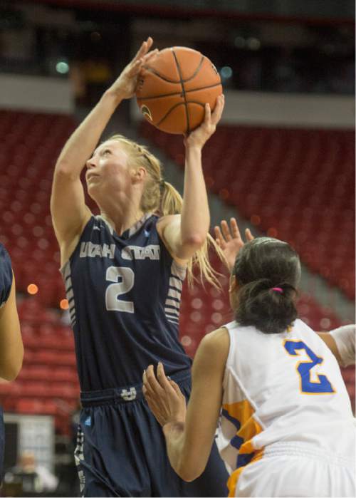 Rick Egan  |  The Salt Lake Tribune

Utah State Aggies guard Elise Nelson (2) gets past San Jose State Spartans guard Nyre Harris (2) for a shot in the Mountain West Conference Basketball Championships at the Thomas & Mack Center in Las Vegas, Monday, March 9, 2015.