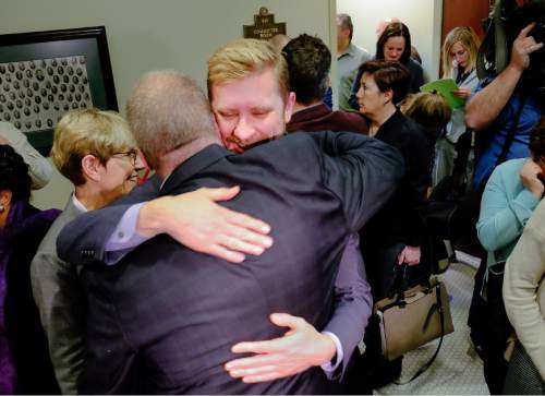 Francisco Kjolseth  |  The Salt Lake Tribune 
Executive Director of Equality Utah Troy Williams, center, gives Sen. Stephen Urquhart, R-St. George, a hug after  SB296 the antidiscrimination bill,  passed the House committee with a favorable recommendation 9-2 on Tuesday, March, 10, 2015. The bill now goes to the full House for debate.