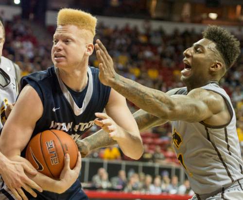 Rick Egan  |  The Salt Lake Tribune

Utah State Aggies forward Sean Harris (30) grabs the ball from Wyoming Cowboys guard Charles Hankerson Jr. (1) in Mountain West Conference Basketball Championship action, Utah State vs. Wyoming, at the Thomas & Mack Center in Las Vegas, Thursday, March 12, 2015.