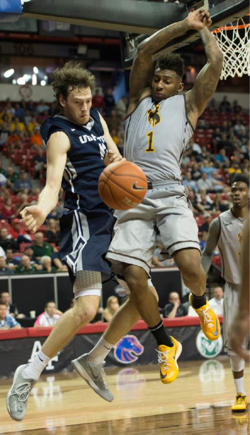 Rick Egan  |  The Salt Lake Tribune

Utah State Aggies forward David Collette (13) collides with Wyoming Cowboys guard Charles Hankerson Jr. (1) in Mountain West Conference Basketball Championship action, Utah State vs. Wyoming, at the Thomas & Mack Center in Las Vegas, Thursday, March 12, 2015.