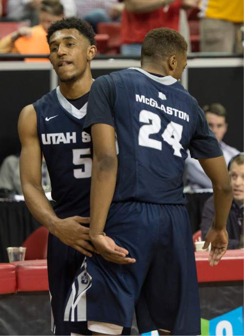 Rick Egan  |  The Salt Lake Tribune

Utah State Aggies guard Julion Pearre (5) and Utah State Aggies guard JoJo McGlaston (24) console each other at the buzzer as the Aggies lost to the Wyoming Cowboys, 65-57 in Mountain West Conference Basketball Championship action, Utah State vs. Wyoming, at the Thomas & Mack Center in Las Vegas, Thursday, March 12, 2015.