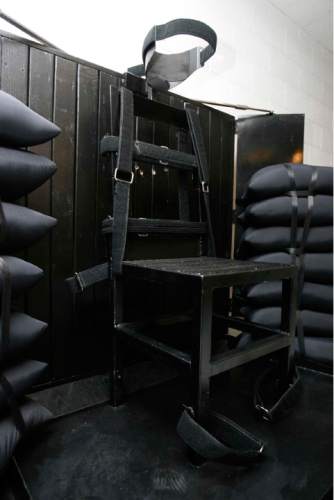 FILE - In this June 18, 2010, file photo, the execution chamber at the Utah State Prison is seen after Ronnie Lee Gardner was executed by firing squad, in Draper, Utah. Four bullet holes are visible in the wood panel behind the chair. Gardner was convicted of aggravated murder, a capital felony, in 1985. Lawmakers have passed a bill that would make Utah the only state to allow firing squads for carrying out a death penalty if there is a shortage of execution drugs. (AP Photo/The Salt Lake Tribune, Trent Nelson, Pool, File)