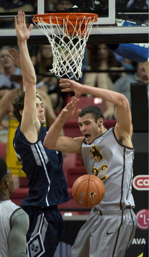 Rick Egan  |  The Salt Lake Tribune

Wyoming Cowboys forward Larry Nance Jr. (22) loses control of the ball as Utah State Aggies forward David Collette (13) defends in Mountain West Conference Basketball Championship action, Utah State vs. Wyoming, at the Thomas & Mack Center in Las Vegas, Thursday, March 12, 2015.
