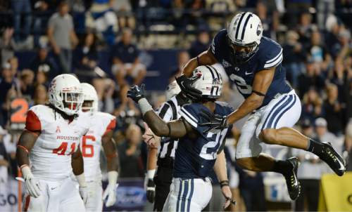 Steve Griffin  |  The Salt Lake Tribune


BYU Cougars wide receiver Colby Pearson (3) leaps onto BYU Cougars running back Jamaal Williams (21) after Williams scored a touchdown in the second half of the  game between BYU and Houston and LaVell Edwards Stadium in Provo, Thursday, September 11, 2014.