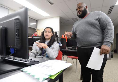 Steve Griffin  |  The Salt Lake Tribune

Earnest Cooper Jr., college access adviser for the University of Utah, helps Granger High School senior Jocelyne Palacio fill out her FAFSA form during a FAFSA Open House put on by the Utah System of Higher Education at Granger High School in West Valley City, Wednesday, March 11, 2015.