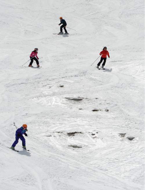 Francisco Kjolseth  |  The Salt Lake Tribune 
The bald spots came early this year as skiers make their way down the slopes at Solitude Mountain Resort in spring skiing conditions on Wednesday, March 18, 2015.