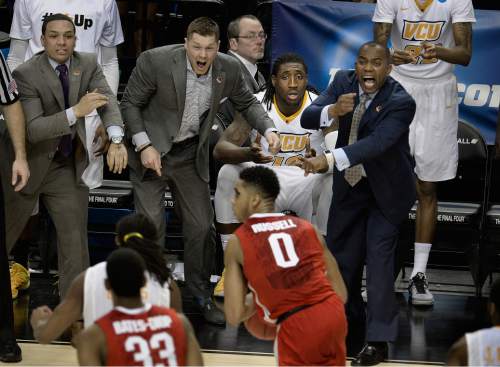 Scott Sommerdorf   |  The Salt Lake Tribune
Players and coaches on the VCU bench yell to could as the game gets out of reach near the end of OT the period. Ohio State defeated VCU 75-72 in OT at the Moda Center in Portland, Thursday, March 19, 2015.