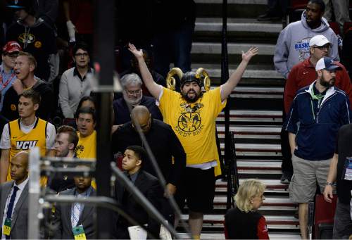 Scott Sommerdorf   |  The Salt Lake Tribune
VCU fans begin to see the inevitable loss near the end of the OT period. Ohio State defeated VCU 75-72 in OT at the Moda Center in Portland, Thursday, March 19, 2015.