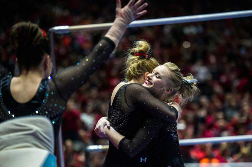 Chris Detrick  |  The Salt Lake Tribune
Utah's Georgia Dabritz gets a hug from Tory Wilson after scoring a perfect 10 on the bars during the gymnastics meet against Michigan at the Jon M. Huntsman Center Friday March 6, 2015. Utah defeated Michigan 198.250 to 197.675.