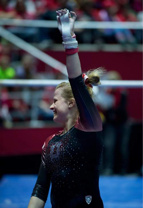 Lennie Mahler  |  The Salt Lake Tribune
Tory Wilson cheers as she dismounts the bars in a super meet at the Huntsman Center on Friday, Jan. 16, 2015.