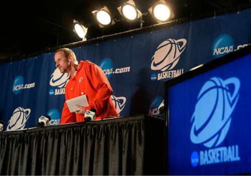 Scott Sommerdorf   |  The Salt Lake Tribune
Utah Utes head coach Larry Krystkowiak sits down prior to speaking to reporters during the Utah press conference at the Moda Center in Portland, Wednesday, March 18, 2015. Utah will play Stephen F. Austin Thursday.