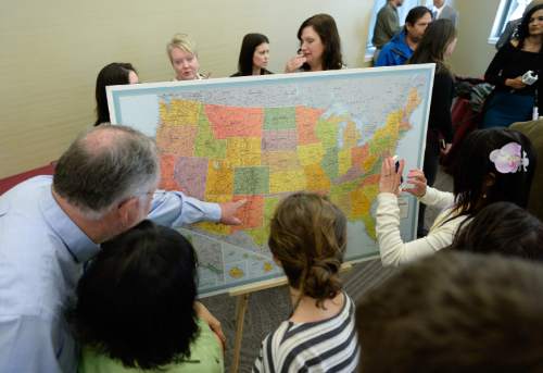 Francisco Kjolseth  |  The Salt Lake Tribune 
Family and friends gather around the map at the University of Utah that will soon reveal where the medical graduate students will do their residency before they open their envelopes for match day.