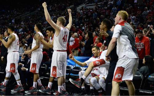 Scott Sommerdorf   |  The Salt Lake Tribune
Utah players celebrate as the team pulled away in the closing seconds to seal the win. after the Utes won their first NCAA tournament game in ten years.  Utah defeated Stephen F. Austin 57-50 at the Moda Center in Portland, Thursday, March 19, 2015.