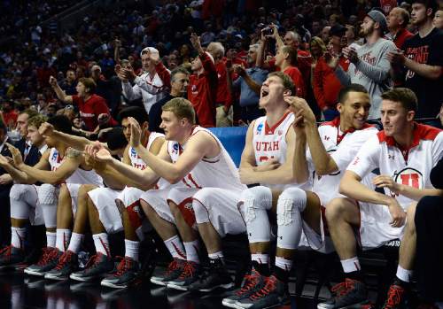 Scott Sommerdorf   |  The Salt Lake Tribune
Utah players, including Utah center Dallin Bachynski (31), yelling, celebrate as the team pulled away in the closing seconds to seal the win. after the Utes won their first NCAA tournament game in ten years.  Utah defeated Stephen F. Austin 57-50 at the Moda Center in Portland, Thursday, March 19, 2015.