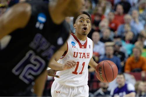 Scott Sommerdorf   |  The Salt Lake Tribune
Utah guard Brandon Taylor (11) communicates with team mates as he brings the ball up during second half play. Utah defeated Stephen F. Austin 57-50 at the Moda Center in Portland, Thursday, March 19, 2015.