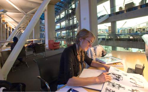 Rick Egan  |  The Salt Lake Tribune

Amanda Kochenash works on a project in the Salt Lake City Library, Monday, December 8, 2014. There is a proposal to keep the first two floors of the Salt Lake Public Library open 24/7, including the reading area on the south side.