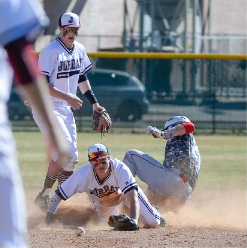 Francisco Kjolseth  |  The Salt Lake Tribune 
Tate Hathaway, bottom, of Jordan High tries to regain control of the ball at second base as Josh Cowley of Woods Cross slides in during game action on Thursday, March 19, 2015 in Sandy.
