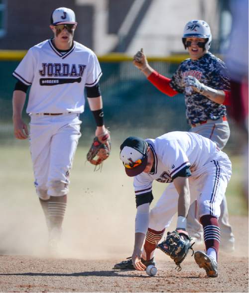 Francisco Kjolseth  |  The Salt Lake Tribune 
Tate Hathaway, bottom, of Jordan High tries to regain control of the ball at second base as Josh Cowley of Woods Cross slides in during game action on Thursday, March 19, 2015 in Sandy.