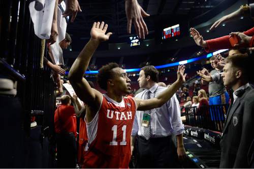 Scott Sommerdorf   |  The Salt Lake Tribune
Utah Utes guard Brandon Taylor (11) is congratulated by fans as he leaves the court. Utah defeated Georgetown 75-64 to advance to the "Sweet Sixteen", Saturday, March 21, 2015.