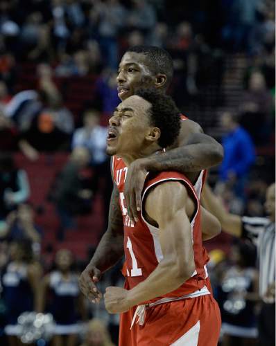 Scott Sommerdorf   |  The Salt Lake Tribune
Utah Utes guard Delon Wright (55) hugs team mate Brandon Taylor (11) after the final horn sounded and Utah defeated Georgetown 75-64 to advance to the "Sweet Sixteen", Saturday, March 21, 2015.