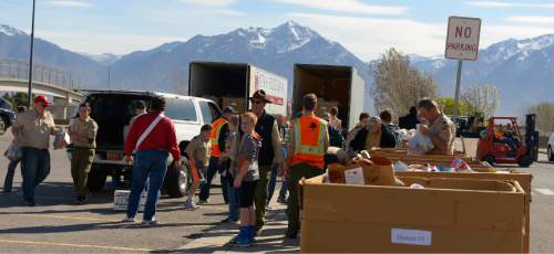 Leah Hogsten  |  The Salt Lake Tribune
Scouts unload food from cars pulling into the Elkridge Elementary collection point. Utah Boy  Scouts of America collected food donations during the 29th Annual Scouting for Food drive to benefit the Utah Food Bank, regional food banks and emergency food pantries across the state, Saturday, March 21, 2015. Last year's drive collected more than 1.3 million meals for Utahns in need.