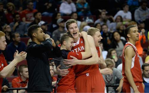 Scott Sommerdorf   |  The Salt Lake Tribune
Utah Utes forward Jakob Poeltl (42) is hugged by Utah Utes guard Austin Eastman (15) as the Utes stretched their lead to ten points very late in the game. Utah defeated Georgetown 75-64 to advance to the "Sweet Sixteen", Saturday, March 21, 2015.