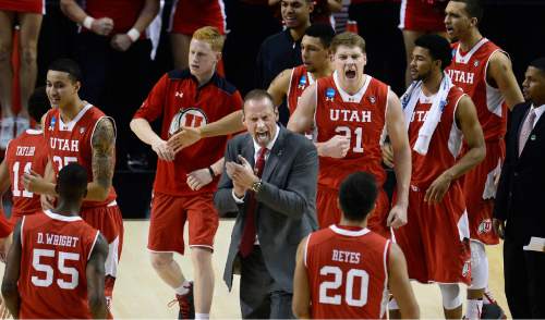 Scott Sommerdorf   |  The Salt Lake Tribune
Utah Utes head coach Larry Krystkowiak congratulates his team after a god run during a first half time out. Utah and Georgetown were tied 32-32 at the half, Saturday, March 21, 2015.