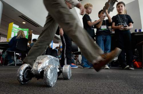 Scott Sommerdorf   |  The Salt Lake Tribune
One of over 200 judges steps over a motorized car, driven by Samuel Soto from Millcreek Elementary, on his way to judge one of the 681 science projects entered in the Salt Lake Valley Science and Engineering Fair, held at the University of Utah, Wednesday, March 25, 2015.