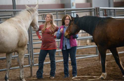 Al Hartmann  |  The Salt Lake Tribune 
Mental health counselors Carissa Palmberg, left, and Bernadette Madara try to gain the trust of horses at the Equine Assisted Growth and Learning Association 16th annual conference at Legacy Arena in Farmington Thursday March 26, 2015. EAGALA is a Santaquin-based nonprofit that uses horses in therapy for veterans, couples and at-risk youth as well as for corporate team-building. The method can be used with or to replace talk therapy. EAGALA says it has more than 4,500 members in 50 countries in Africa, North America, the Middle East, Latin America and Australia, who are using its techniques.