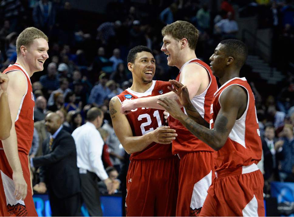 Scott Sommerdorf   |  The Salt Lake Tribune
Utah celebrates it's win over Georgetwn. Left to right are; Utah Utes forward Jeremy Olsen (41), Utah Utes forward Jordan Loveridge (21), Utah Utes forward Jakob Poeltl (42) and Utah Utes guard Delon Wright (55). Utah defeated Georgetown 75-64 to advance to the "Sweet Sixteen", Saturday, March 21, 2015.