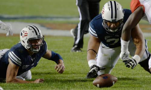 Steve Griffin  |  The Salt Lake Tribune


BYU Cougars offensive linesman Ului Lapuaho (71) falls on the football after BYU Cougars quarterback Taysom Hill (4), left, fumbled the football in the second half of the  game between BYU and Houston and LaVell Edwards Stadium in Provo, Thursday, September 11, 2014.